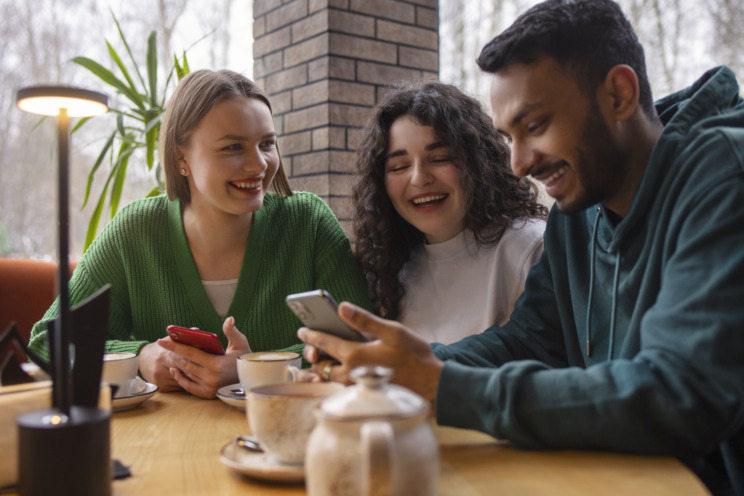 A photo of a group of friends chatting at a café.
