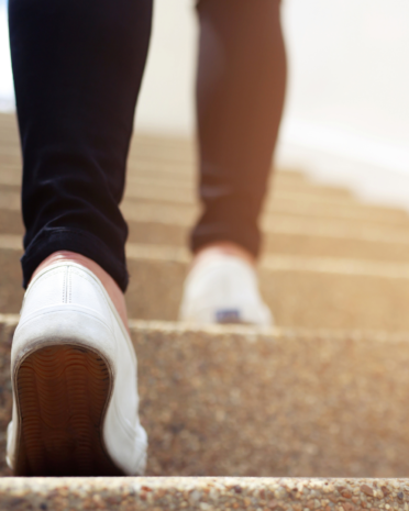 Photo of a person walking up steps.